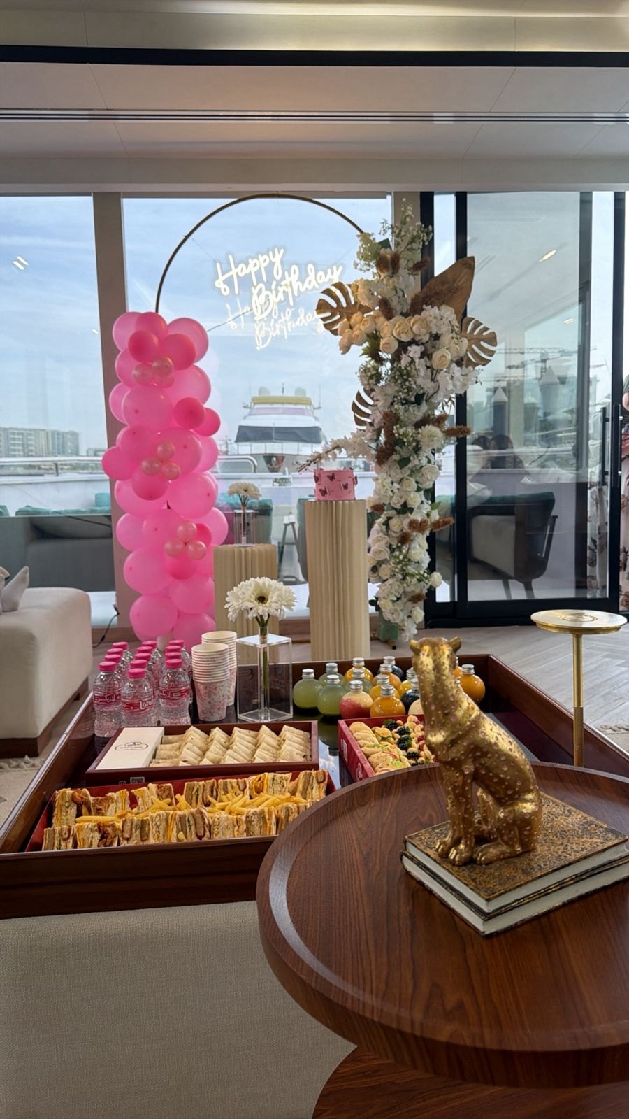 Pink balloon event setup overlooking the water